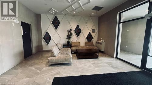 Tile flooring, decorative wall paneling, large glass entrance, recessed lighting - 1 Wellington Street Unit# 308, Brantford, ON 