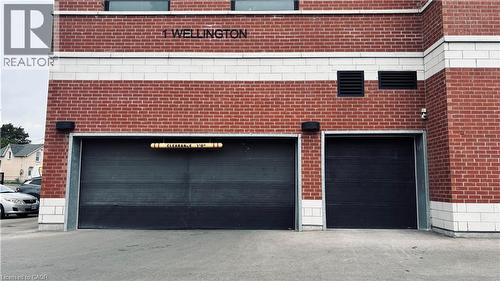Brick facade with two roll-up garage doors - 1 Wellington Street Unit# 308, Brantford, ON 