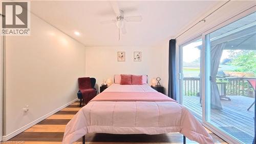 Wood-finish flooring, sliding glass door, recessed lighting, ceiling fan, and outdoor wood deck - 380 Grangewood Drive, Waterloo, ON 