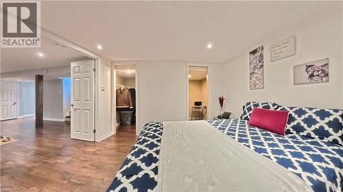 Recessed lighting, wood-finish flooring, white paneled doors, and a built-in closet with shelving - 380 Grangewood Drive, Waterloo, ON 