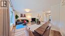 Wood-finish flooring throughout, bay window with curtain rods, and recessed wall shelving - 380 Grangewood Drive, Waterloo, ON 