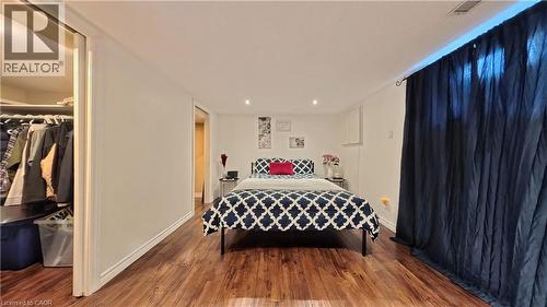 Wood-finish flooring, recessed lighting, and a window with a blackout curtain - 380 Grangewood Drive, Waterloo, ON 