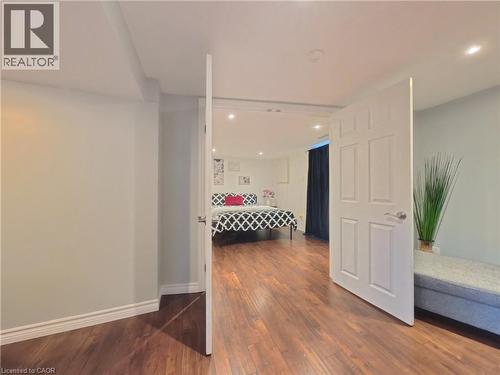 Wood-finish flooring throughout, white interior doors with satin nickel hardware, recessed lighting, and light-toned walls - 380 Grangewood Drive, Waterloo, ON 
