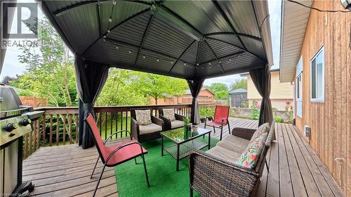 Expansive wood deck featuring a covered gazebo with string lighting, and a durable metal railing system - 380 Grangewood Drive, Waterloo, ON 