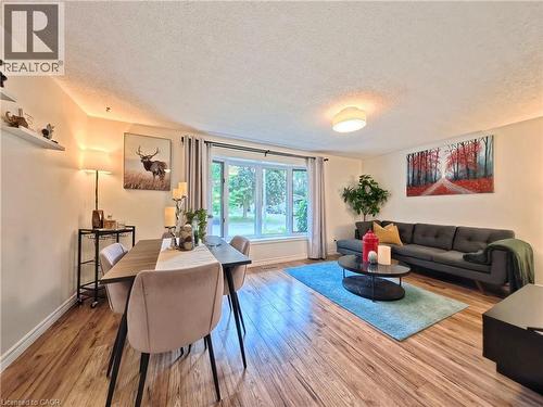 Wood-finish flooring, bay window, recessed lighting, and a drum ceiling light fixture - 380 Grangewood Drive, Waterloo, ON 