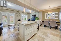 Kitchen island featuring a granite countertop and built-in storage - 