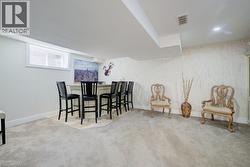 Recessed lighting illuminates a built-in bar with countertop, complemented by light-toned wall finishes and a window with blinds - 