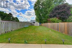 Fully fenced backyard with garden shed - 