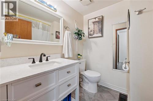 White vanity with integrated sink, dark bronze-finish faucet, and substantial wall-mounted mirror - 46 Cedarwoods Crescent Unit# 53, Kitchener, ON - Indoor Photo Showing Bathroom
