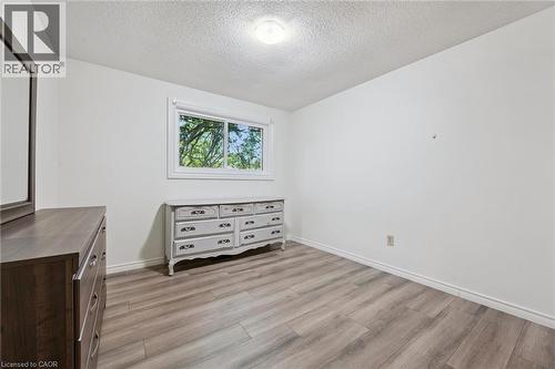 Wood-finish flooring, white walls, and a window providing natural illumination - 46 Cedarwoods Crescent Unit# 53, Kitchener, ON - Indoor