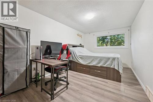 Wood-finish flooring, white walls, and a window with exterior visibility - 46 Cedarwoods Crescent Unit# 53, Kitchener, ON - Indoor