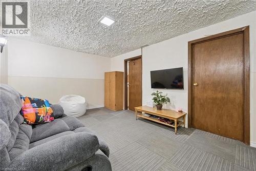 Recessed ceiling light, two panel doors with wood-finish, light-colored wall paneling, and patterned tile flooring - 46 Cedarwoods Crescent Unit# 53, Kitchener, ON - Indoor