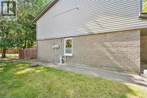 Exterior featuring light gray siding and brick lower level - 46 Cedarwoods Crescent Unit# 53, Kitchener, ON - Outdoor