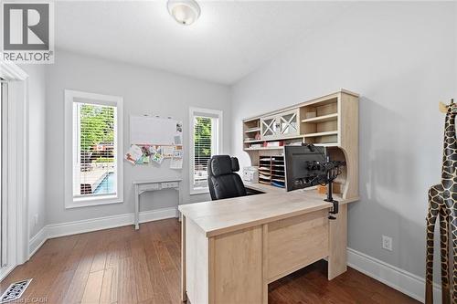 Wood-finish flooring with white trim, built-in desk unit, and a ceiling-mounted light fixture - 2312 Ridgeview Court, Burlington, ON - Indoor Photo Showing Office