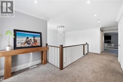 Carpeted hallway with a wood and white spindle railing, recessed lighting, and crown molding - 2312 Ridgeview Court, Burlington, ON - Indoor Photo Showing Other Room