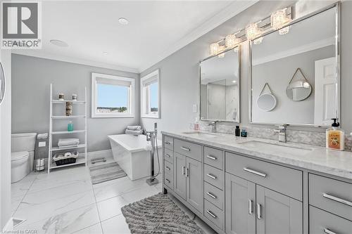 Dual vanity with gray cabinetry and white countertop, freestanding soaking tub, large format tile flooring, and recessed lighting - 2312 Ridgeview Court, Burlington, ON - Indoor Photo Showing Bathroom