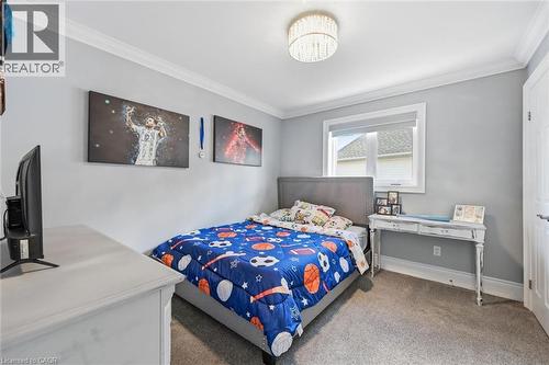 Recessed window, crown molding, bed with upholstered headboard, flush-mount ceiling light fixture, and carpeted flooring - 2312 Ridgeview Court, Burlington, ON - Indoor Photo Showing Bedroom