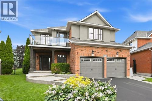 Brick and stucco exterior with an upper-level balcony featuring glass railings - 2312 Ridgeview Court, Burlington, ON - Outdoor