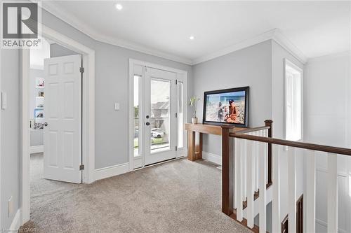 Recessed lighting, crown molding, double French doors, wood-finish handrail, and carpeted flooring - 2312 Ridgeview Court, Burlington, ON - Indoor Photo Showing Other Room