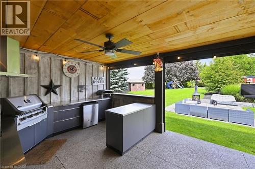 Outdoor kitchen featuring a built-in grill, stainless steel refrigerator, and wood-paneled ceiling with an integrated ceiling fan - 2312 Ridgeview Court, Burlington, ON - Outdoor With Exterior