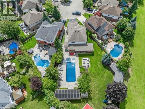 Expansive property featuring a rectangular pool, a separate freeform pool, and an outdoor patio with seating - 2312 Ridgeview Court, Burlington, ON - Outdoor With In Ground Pool With View