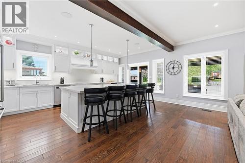 Expansive kitchen featuring white cabinetry, a large center island with pendant lighting, and stainless steel appliances - 2312 Ridgeview Court, Burlington, ON - Indoor Photo Showing Kitchen With Upgraded Kitchen