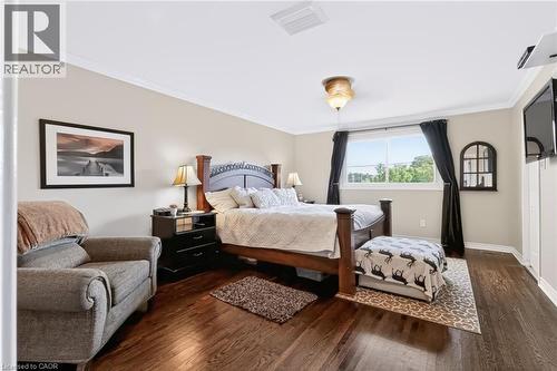 Hardwood flooring, crown molding, double window, ceiling fan with light fixture, and white trim - 4248 Dunvegan Road, Burlington, ON 