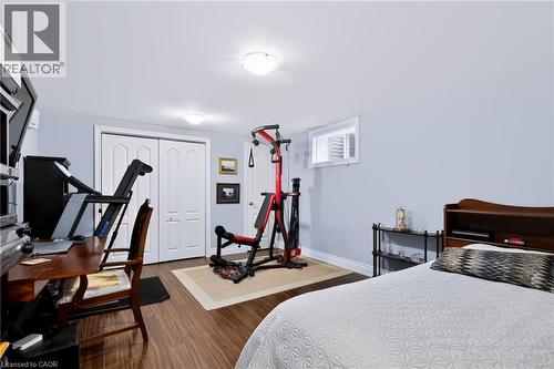 Wood-finish flooring, recessed lighting, double bi-fold closet doors, and a single window with blinds - 4248 Dunvegan Road, Burlington, ON 