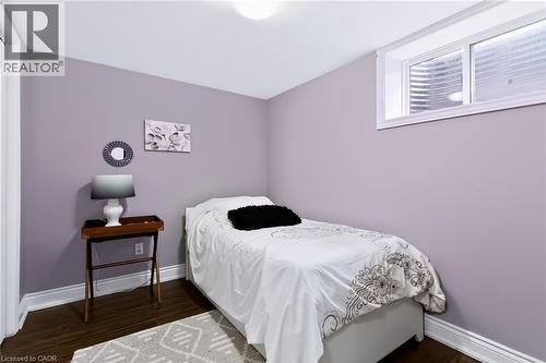 Wood-finish flooring with white trim, a transom window, and an overhead light fixture - 4248 Dunvegan Road, Burlington, ON 