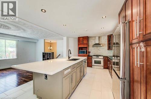 Spacious kitchen featuring a large central island, stainless steel appliances, wood cabinetry, and recessed lighting - 109 White Oak Place, Waterloo, ON - Indoor Photo Showing Kitchen With Double Sink With Upgraded Kitchen