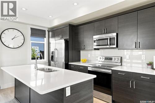 703 Meadows Boulevard, Saskatoon, SK - Indoor Photo Showing Kitchen With Double Sink With Upgraded Kitchen