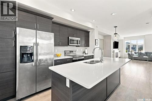 703 Meadows Boulevard, Saskatoon, SK - Indoor Photo Showing Kitchen With Stainless Steel Kitchen With Double Sink With Upgraded Kitchen