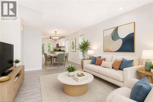 Open-concept living area with wood-finish flooring, recessed lighting, and ample natural light - 47 Queensway Drive, Strathroy, ON - Indoor Photo Showing Living Room