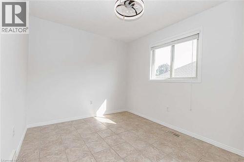 Recessed window with blinds, white walls, ceiling-mounted light fixture, and tiled flooring - 47 Queensway Drive, Strathroy, ON - Indoor Photo Showing Other Room