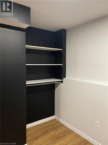 Built-in closet system with shelving and hanging rod - 47 Queensway Drive, Strathroy, ON - Indoor Photo Showing Other Room
