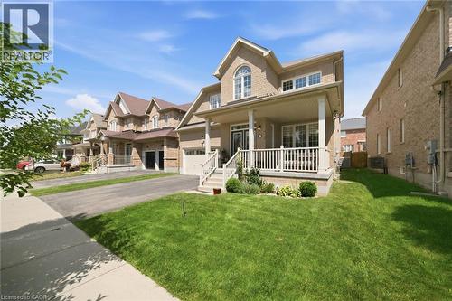 Brick exterior with a covered front porch featuring white railings - 57 Cheevers Road, Brantford, ON - Outdoor With Deck Patio Veranda With Facade