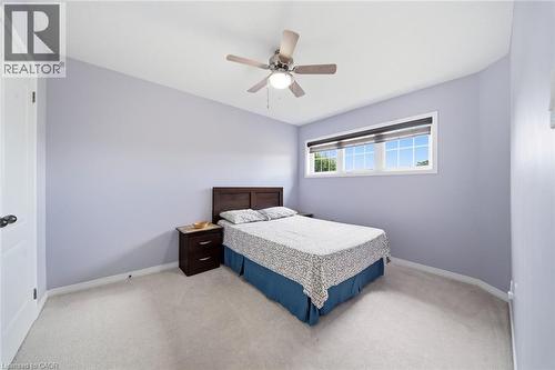 Light gray wall tones with white trim, ceiling fan with integrated lighting, and a window with a roller shade - 57 Cheevers Road, Brantford, ON - Indoor Photo Showing Bedroom