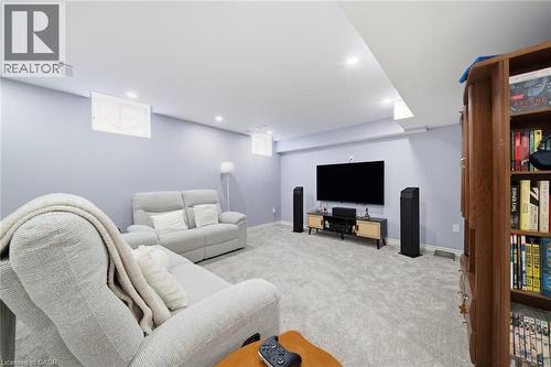 Recessed lighting illuminates the carpeted floor and light-toned walls - 57 Cheevers Road, Brantford, ON - Indoor