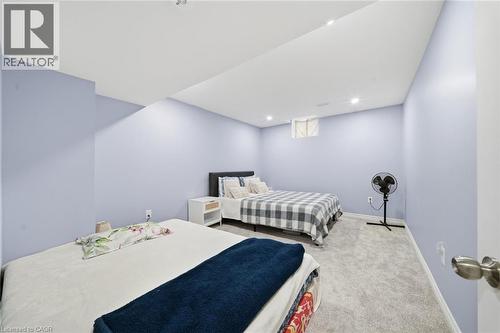 Recessed lighting, light blue wall paint, gray carpet flooring, and a single window - 57 Cheevers Road, Brantford, ON - Indoor Photo Showing Bedroom