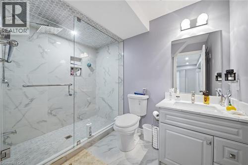 Walk-in shower with clear glass enclosure, rainfall showerhead, and recessed shelf niches - 57 Cheevers Road, Brantford, ON - Indoor Photo Showing Bathroom