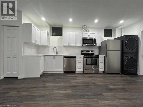 Kitchen featuring white cabinetry, stainless steel appliances, wood-finish flooring, and recessed lighting - 31 Sofitel Drive, Kitchener, ON - Indoor Photo Showing Kitchen