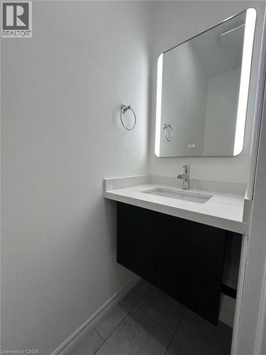 Floating vanity with a light-toned countertop, integrated sink, and chrome faucet - 31 Sofitel Drive, Kitchener, ON - Indoor Photo Showing Bathroom