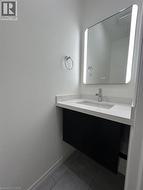 Floating vanity with a light-toned countertop, integrated sink, and chrome faucet - 