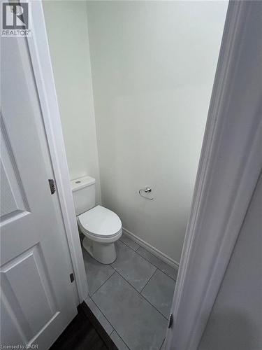 White two-piece toilet on a tile floor - 31 Sofitel Drive, Kitchener, ON - Indoor Photo Showing Bathroom