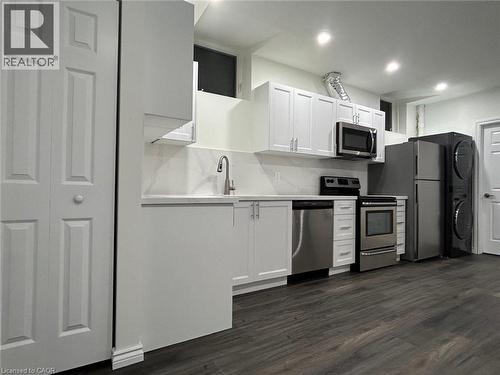 Kitchen featuring white cabinetry, stainless steel appliances, wood-finish flooring, and recessed lighting - 31 Sofitel Drive, Kitchener, ON - Indoor Photo Showing Kitchen