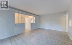 Light wood-finish flooring with white walls and ceiling - 