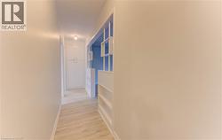 Recessed ceiling lighting illuminating wood-finish flooring - 