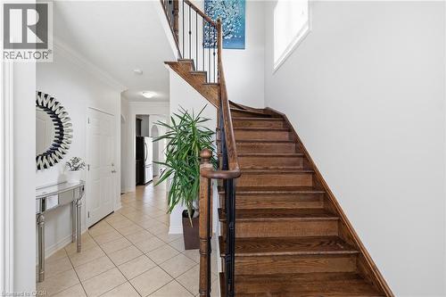 Wood staircase with dark metal spindles and wood handrail - 738 Fourth Line, Milton, ON - Indoor Photo Showing Other Room