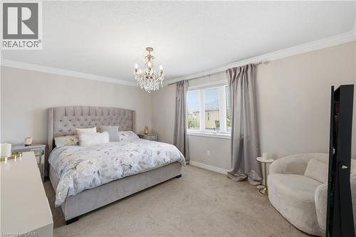 Neutral wall color, crown molding, double window with curtains, chandelier, and carpeted flooring - 738 Fourth Line, Milton, ON - Indoor Photo Showing Bedroom