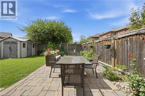 Expansive backyard featuring a paver patio, manicured lawn, and a storage shed - 738 Fourth Line, Milton, ON - Outdoor With Deck Patio Veranda